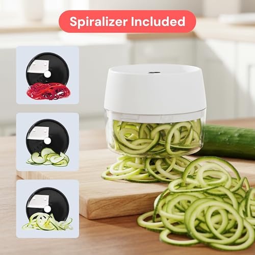 Spiralizer with zucchini noodles on a wooden cutting board