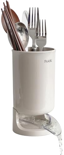 White fluidic kitchen sink with cutlery holder on a white background