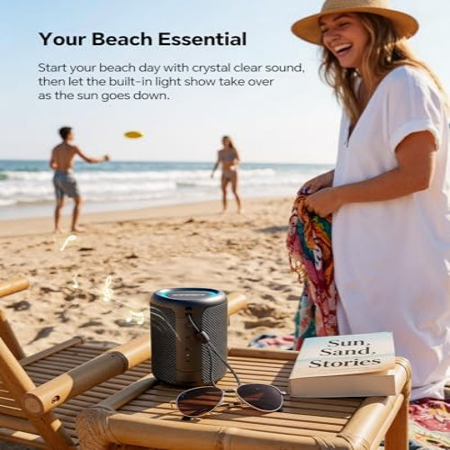Woman on a beach with a speaker, sunglasses, and a book titled 'Sun, Sand, Stories'.