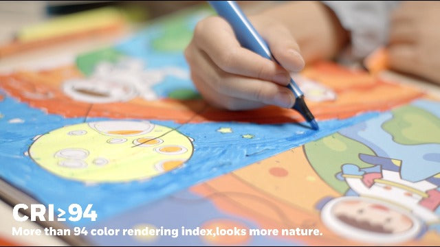 Child's hand holding a marker over a coloring book with vibrant colors.