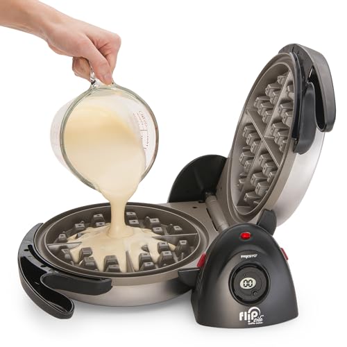 Waffle maker with batter being poured into it on a white background