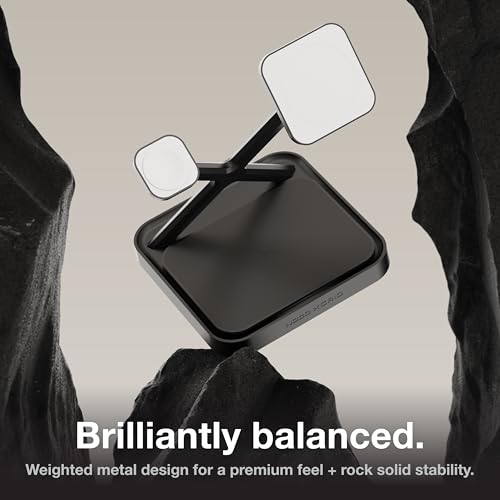 Black metal object with square weights held by a person, on a neutral background.